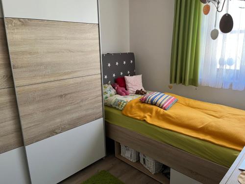 a small bedroom with a bed and a closet at Haus Schneebergblick in Röslau