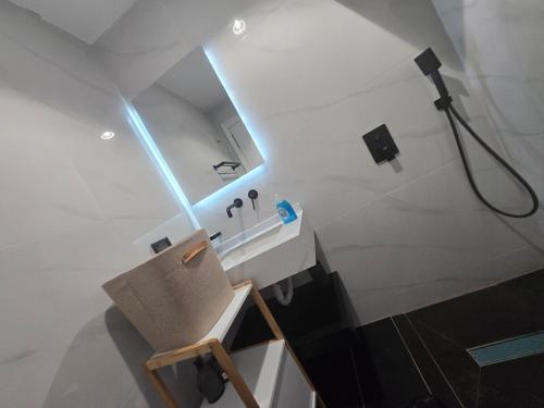a bathroom with a sink and a light on the ceiling at Elegance appart-Yoff virage in Dakar