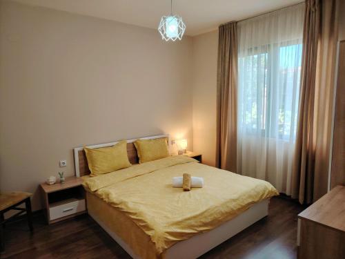 a bedroom with a bed with a cross on it at Къща за гости Азария in Resilovo