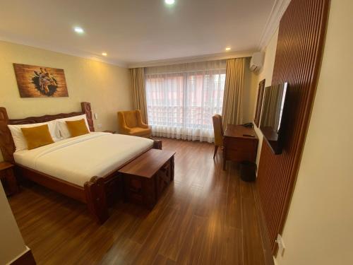 a hotel room with a bed and a television at Progressive Park Hotel in Nairobi