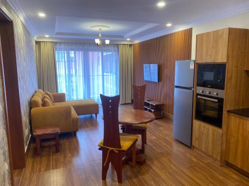 a living room with a kitchen and a living room with a table at Progressive Park Hotel in Nairobi