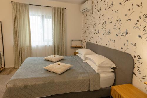 a bedroom with a bed with birds on the wall at No. 55 in Buzău