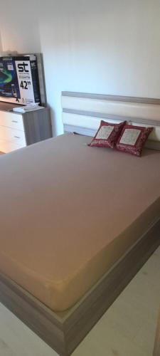 a bed with two pillows sitting on top of it at Apartment LUX in Struga
