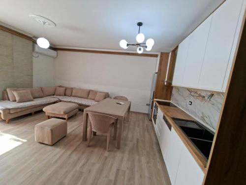 a living room with a couch and a table at Rafaelo Apartament in Lezhë