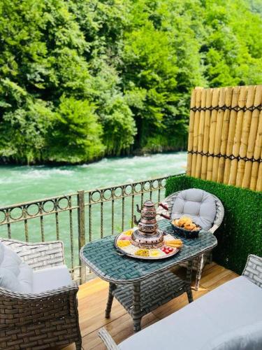 a table with a bowl of food on a patio at Elegant Residence in Çamlıhemşin