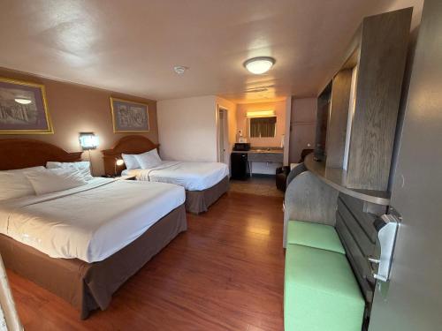 a hotel room with two beds and a bathroom at Americas Best Value Inn Eugene in Eugene