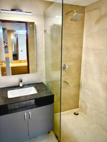 a bathroom with a sink and a shower at The Novaire in Lucknow