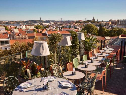 a row of tables and chairs on a roof at Mama Shelter Lisboa in Lisbon