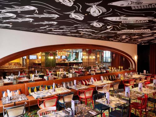 a dining room filled with tables and chairs at Mama Shelter Lisboa in Lisbon