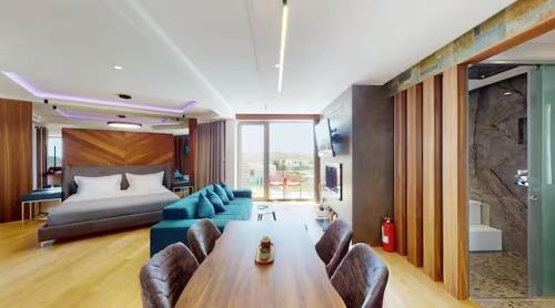 a living room with a couch and a table and a bed at Bliss Properties Jacuzzi Suite Free Pool Access in Draç