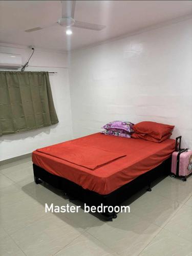 a bedroom with a red bed in a room at NiNo in Vaitele