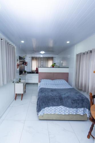 a bedroom with a large bed and a white floor at Casa do Henrique 2 in Sorocaba