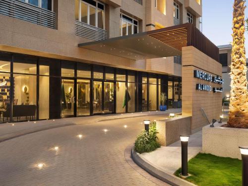 a building with a courtyard in front of it at Mercure Riyadh Al Anoud in Riyadh