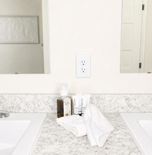 a bathroom with two sinks and towels on a counter at Beautiful, Cozy home in Concord in Concord