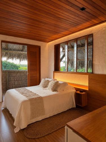 a bedroom with a large bed with a window at Bali Atins in Atins