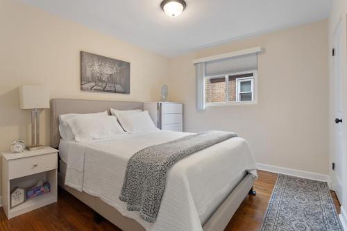 a bedroom with a white bed and a window at Chicago Charm in Chicago