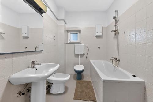 a white bathroom with a sink and a toilet at Room Blue View in Mlini