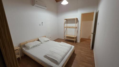 a small bedroom with a bed and a ladder at Platres Villas in Kato Platres