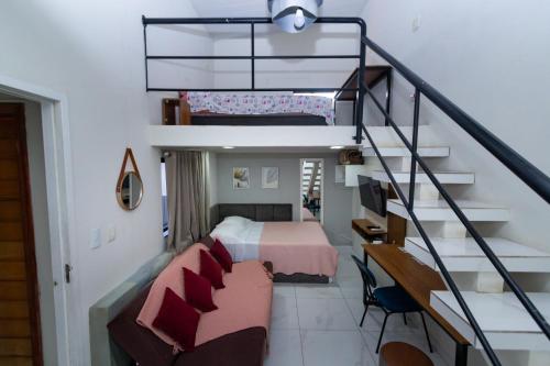 a bedroom with a bed and a staircase at Casa do Henrique 1 in Sorocaba