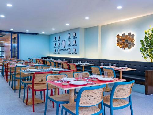 a row of tables and chairs in a restaurant at ibis Styles Kuala Lumpur Bukit Bintang in Kuala Lumpur