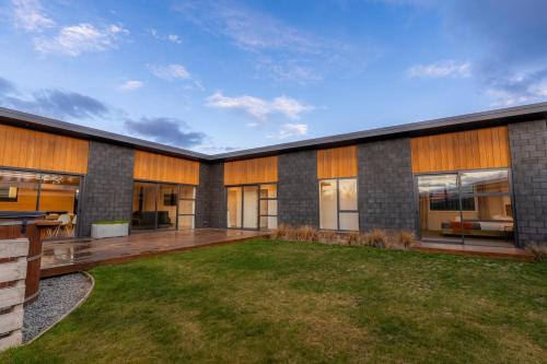 an exterior view of a house with a yard at Totara Haven in Twizel