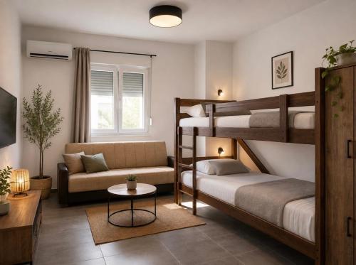 a bedroom with two bunk beds and a couch at Apartments Leyla in Ulcinj