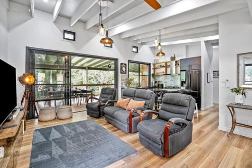 a living room with a couch and chairs and a table at Creekside Cottage, pet friendly w pool in Perwillowen