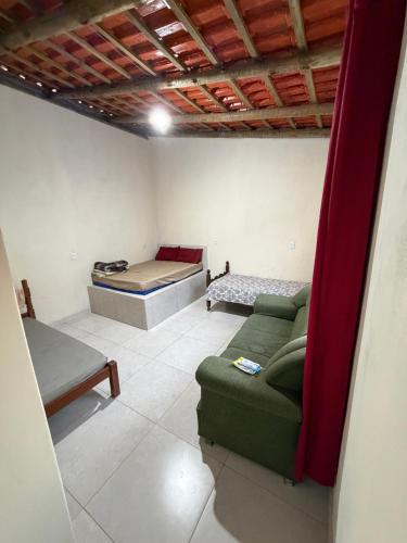a living room with a couch and a bed at Recanto da vale Rs in Três Marias