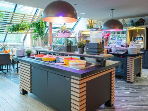 a buffet line with food on display in a restaurant at Novotel Paris Centre Bercy in Paris