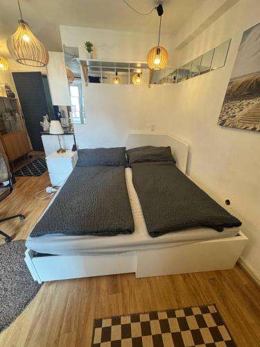 a large white bed in a room with at Old Town Terrace Studio Trier in Trier