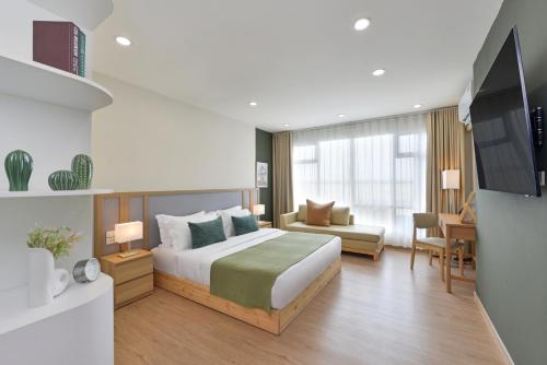 a hotel room with a bed and a tv at SENS Hotel Nonthaburi Bangbuathong in Nonthaburi