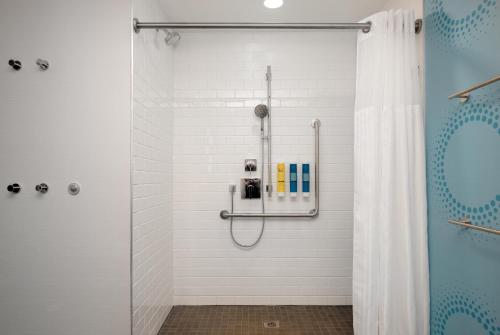a shower with a glass door in a bathroom at Tru By Hilton Gananoque, On in Gananoque