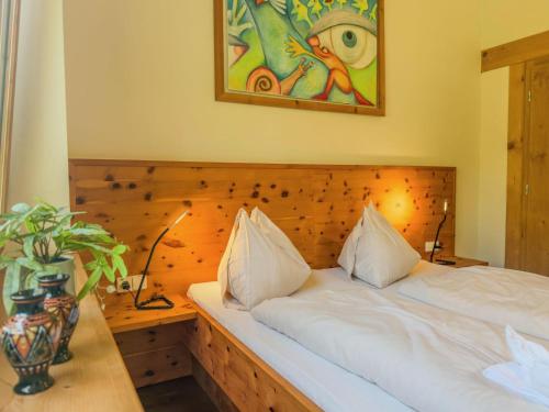a bedroom with a bed with a wooden headboard at Auen 53 in Lake Pressegg