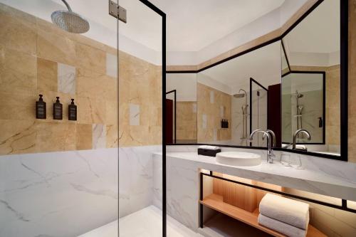 a bathroom with a shower and a sink at Sheraton Jakarta Soekarno Hatta Airport in Tangerang