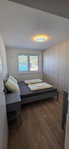 a room with a bed and two windows at Apartmán Hrdličky Trenčín in Trenčín