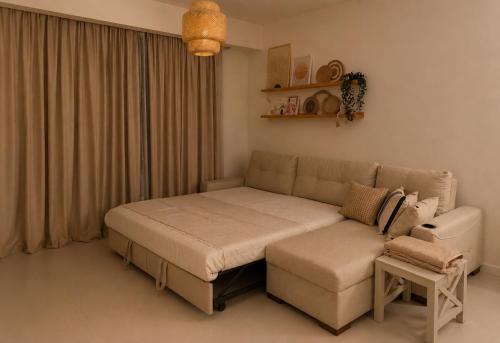 a bed and a couch in a room at Marassi- Faya Residence in El Alamein