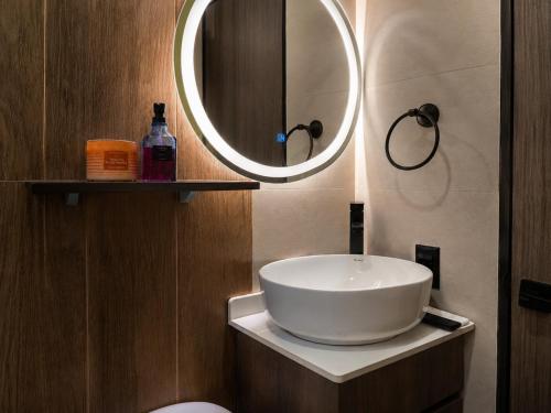 a bathroom with a white sink and a mirror at Akari Privè in Barranca
