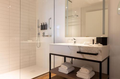 a bathroom with a sink and a shower at Sheraton Nice in Nice