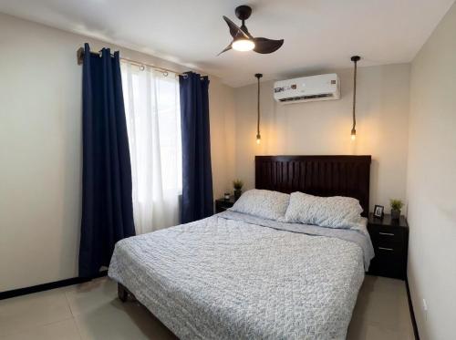 a bedroom with a bed and a ceiling fan at Akari Privè in Barranca