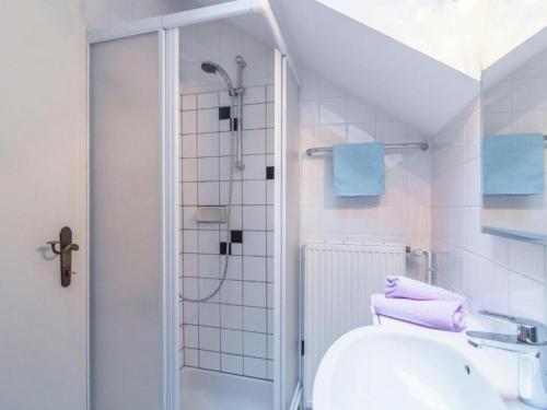 a white bathroom with a shower and a sink at Landhaus Rangersdorf in Rangersdorf