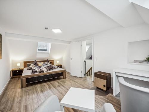 a bedroom with a bed and a living room at Mompels in Rübeland