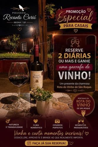a bottle of wine sitting next to a glass at Sítio pousada recanto curió in Ibiúna