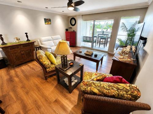a living room with a couch and a table at Wavecrest - 4BR Condos - Sleeps 12 in Kaunakakai
