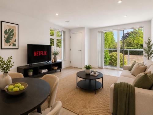 a living room with a couch and a table at 2 Bedroom Addenbrookes Apartment in Trumpington
