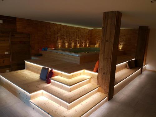 a large room with a tub in the middle at Aqua Apartments Spa Housemuhlbach in Sappada