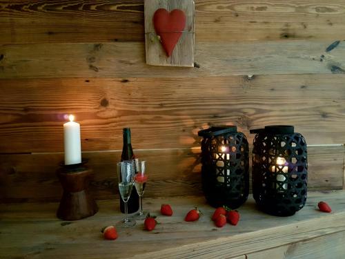two black vases and a candle on a table at Aqua Apartments Spa Housemuhlbach in Sappada