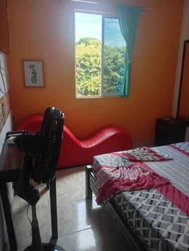 a room with a camera and a bed and a window at Hotel capital in Florencia