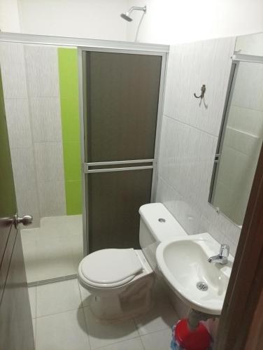 a bathroom with a toilet and a sink at Hotel capital in Florencia