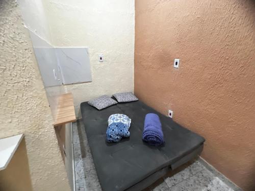 two pillows sitting on a bed in a room at Recanto Carioca Aconchegante in Rio de Janeiro