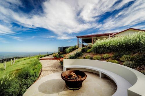a house on a hill with a potted plant at Petrichor Estate - 360 Views Pool & Spa in Bald Knob